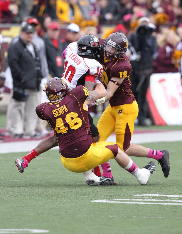 DL Blake Serpa and S Tony Annese combine for a tackle against NIU (Courtesy of CMU Athletics)